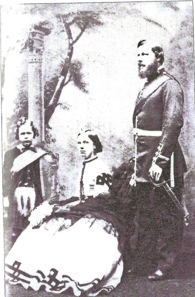 Victorian photograph taken in August 1868 showing Susanna Sneyd seated in a long dress, her brother John William Sneyd standing beside her, and young Ralph Sneyd on the left.